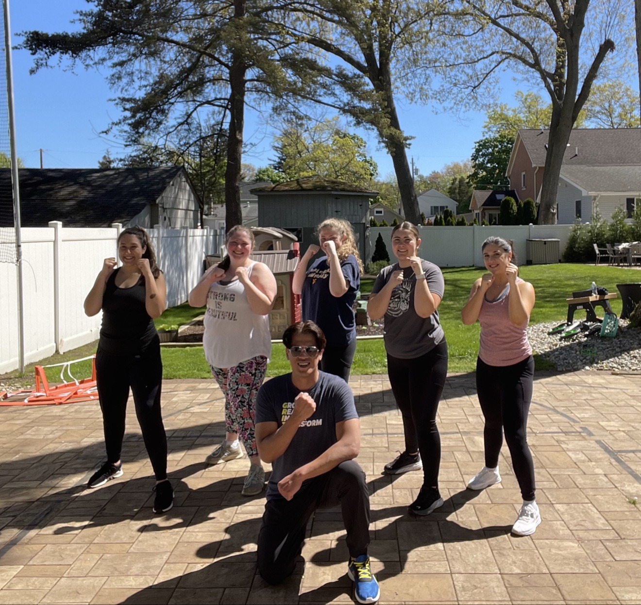 Coach Mike with a group of clients in boxing stance during outdoor group training