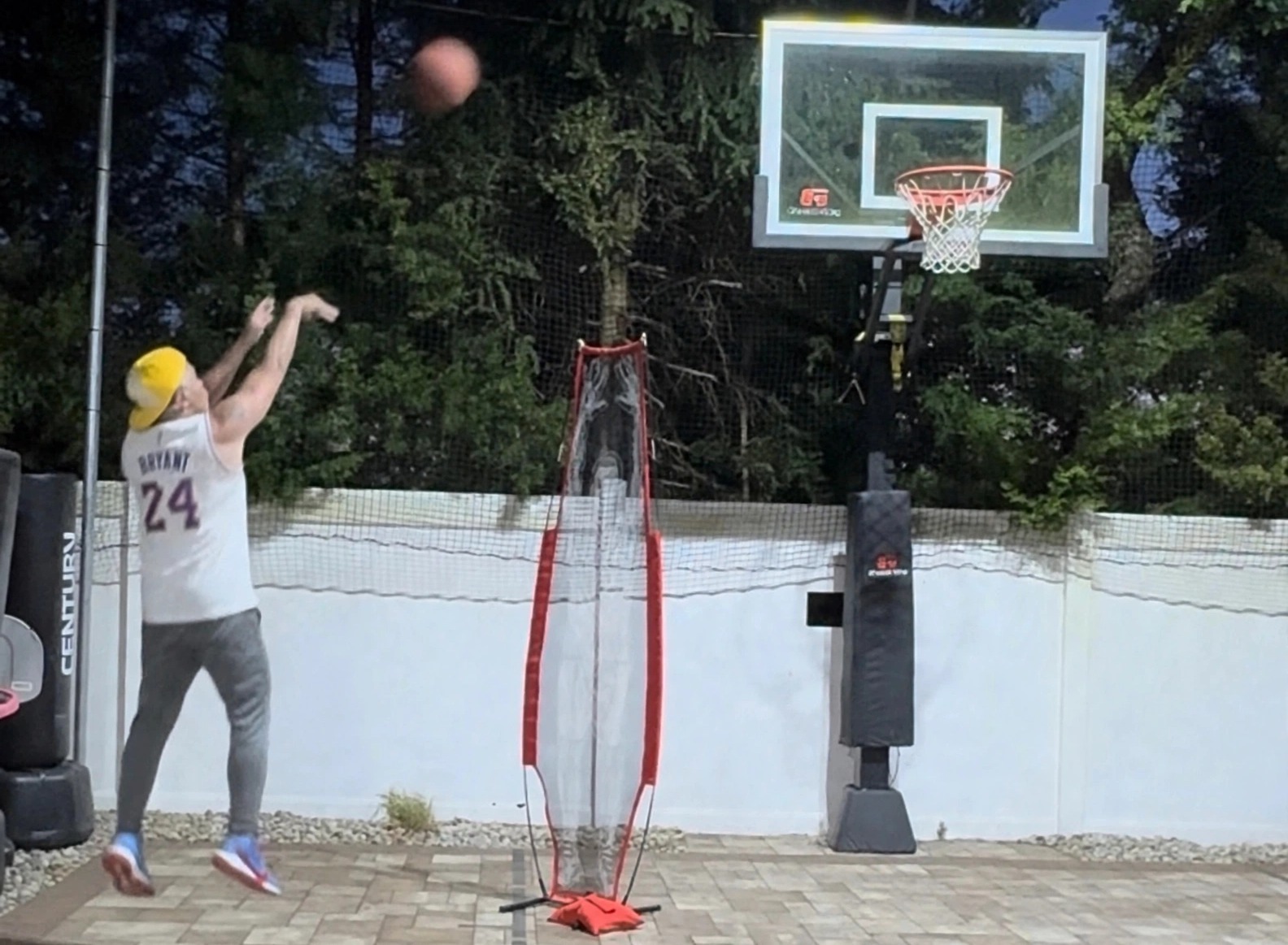 Coach Mike jumping higher for a basketball shot at night