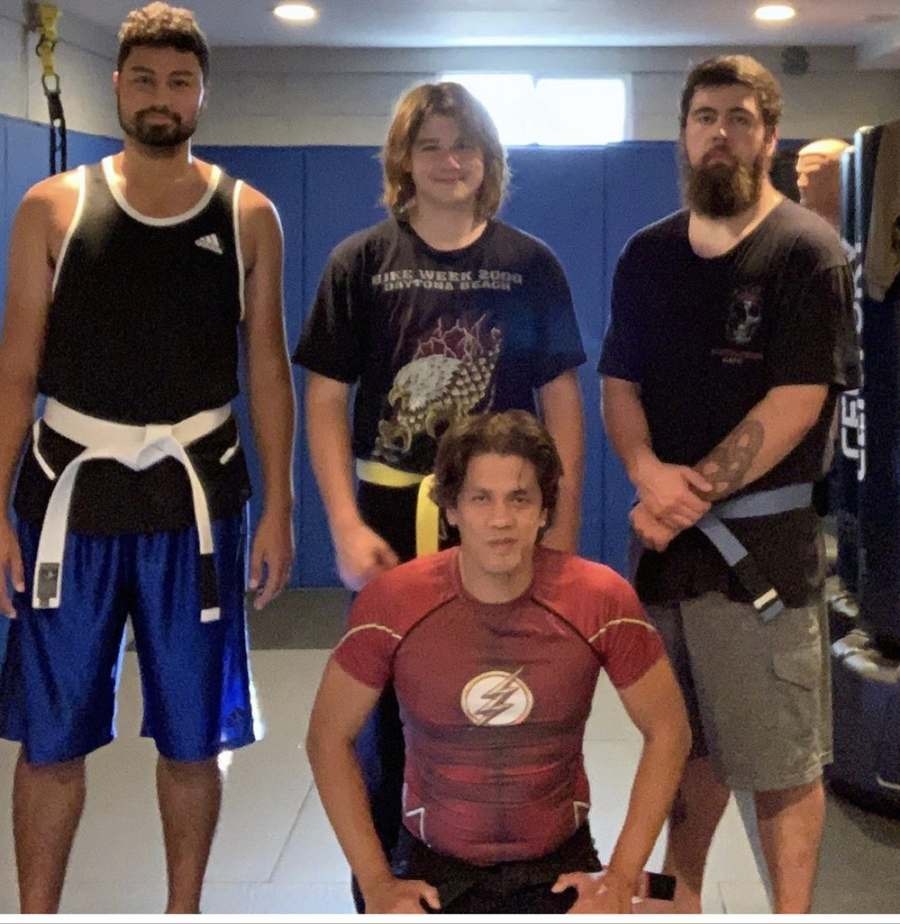 Coach Mike with three martial arts students at Wolf's Den