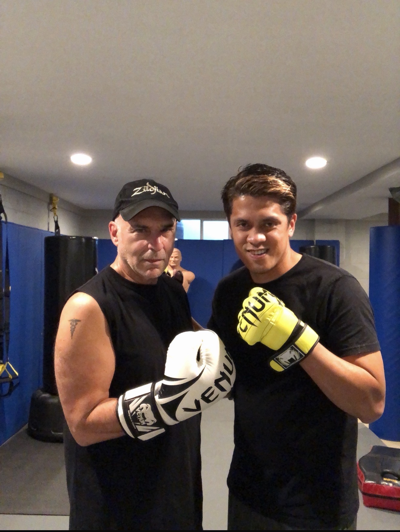 Coach Mike and a boxing client training together in gloves at Wolf's Den